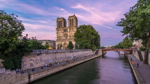 Front view of Notre Dame De Paris cathedral day to night timelapse after su.. Stock Photos