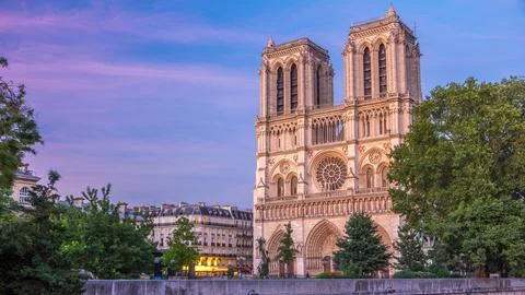Front view of Notre Dame De Paris cathedral day to night timelapse after su.. Stock Photos