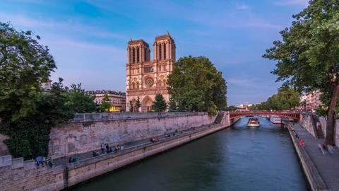 Front view of Notre Dame De Paris cathedral day to night timelapse after su.. Stock Photos