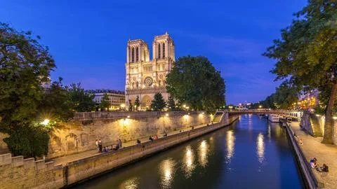 Front view of Notre Dame De Paris cathedral day to night timelapse after su.. Stock Photos
