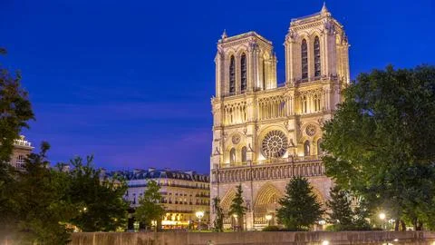 Front view of Notre Dame De Paris cathedral day to night timelapse after su.. 写真素材