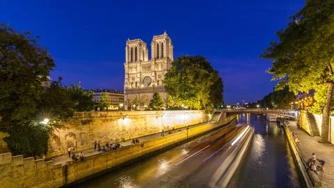 Front view of Notre Dame De Paris cathedral day to night timelapse after su.. Stock Photos
