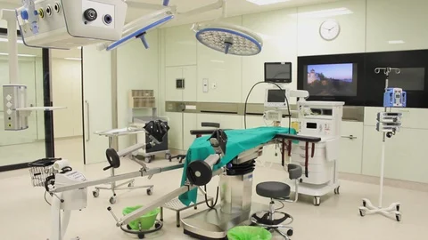 Front view of nurse checking equipment in modular operating theatre. 스톡 동영상 129896799