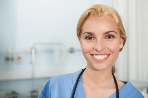 Front view of a nurse smiling while looking at camera Stock Photos