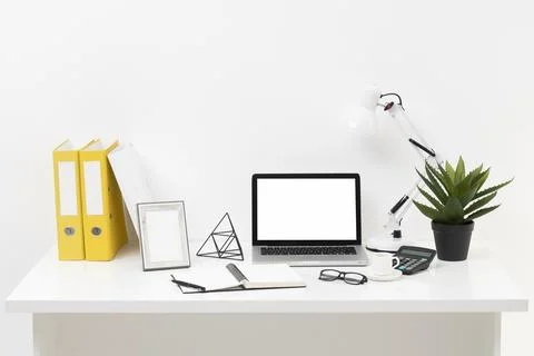 Front view office desk composition with laptop Stock Photos