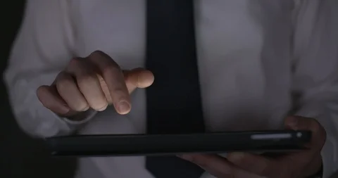 Front view of office worker working late on a tablet, 4k slow motion, glow. Stock Footage 90572247