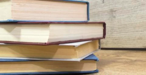 Front view of old books lying on the table. Stock Photos