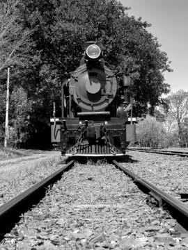 Front view of an old-fashioned steam locomotive in a brazilian railway statio Stock Photos