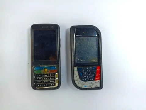 Front view of old Nokia N73 and Nokia 7610 cell phones on a white background Stock Photos
