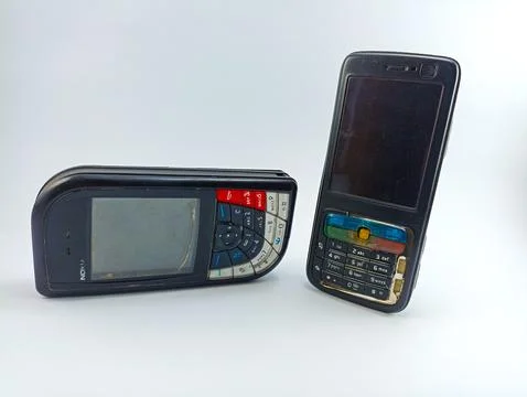 Front view of old Nokia N73 and Nokia 7610 cell phones on a white background Stock Photos