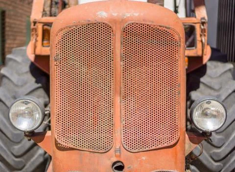 Front view of old red tractor grille and headlights Stock Photos