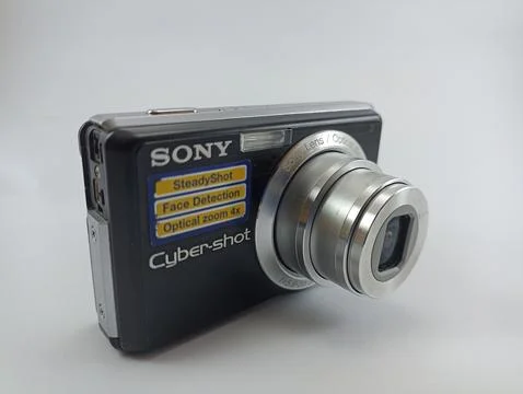 Front view of an old Sony digital pocket camera isolated on a white background Stock Photos