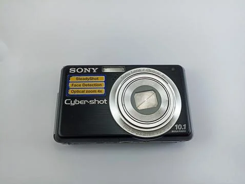 Front view of an old Sony digital pocket camera isolated on a white background Stock Photos