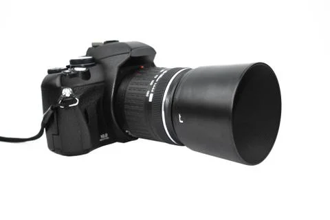 Front view of one black colored camera with lens attached to it placed on a w Stock Photos