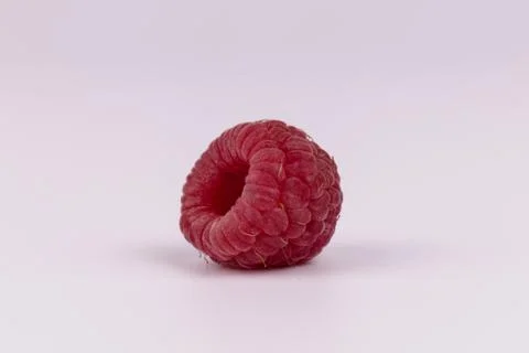 Front view of one isolated fresh small raspberry without leaf Stock Photos