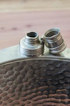 Front view of open metal flask, drinking alcoholism addiction concept Stock Photos