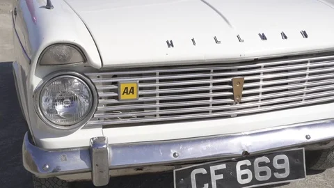 Front view of a open top Hillman Super Minx cabriolet on the beach Stock Footage 116725396