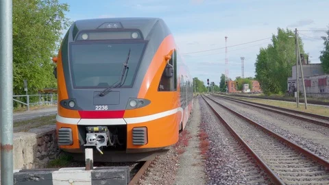 The front view of the orange color train in the station Stock Footage 95786493