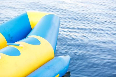 Front view orange Inflatable rubber boat floating on lake in public park. Stock Photos