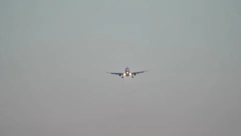 Front view of passenger airplane approaching the airport Stock Footage 240644313