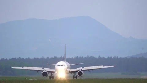 Front view of passenger plane vacating the runway Stock Footage 255963379