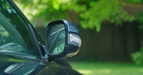Front view of passenger side rear view mirror of a parked luxury car opening Stock Footage 199653943
