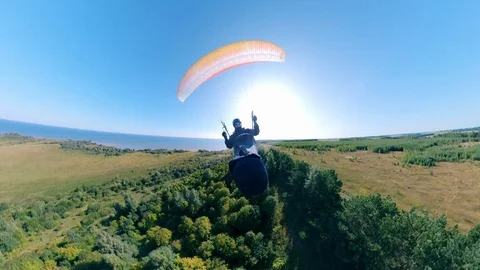 Front view of a person flying with a ram-air parachute. Man Paragliding Stock Footage 117895037