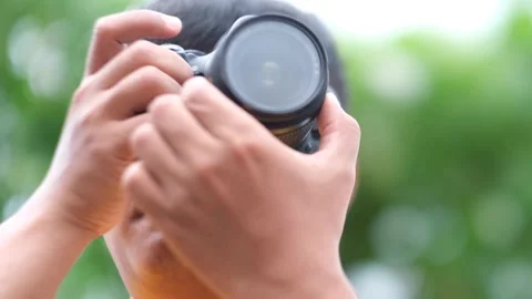 Front view of a person taking a photo with a dslr camera Stock Footage 168920760