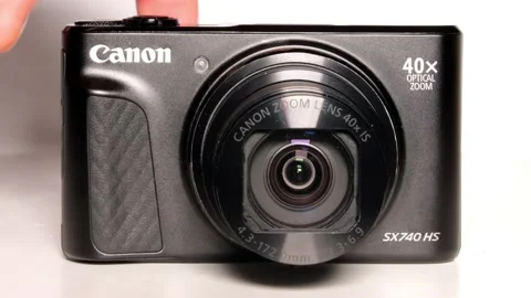 A front view of a person using a Canon PowerShot SX740 Digital Camera Stock Footage 231857295