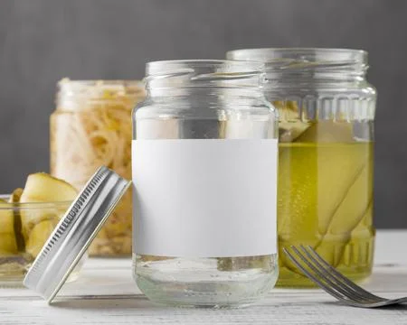 Front view pickled vegetables clear jars Stock Photos