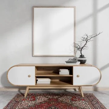 A front view of a picture frame mockup on a white wall, above a wooden cabi.. Stock Photos