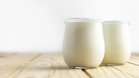 Front view plain yogurt in jars Stock Photos