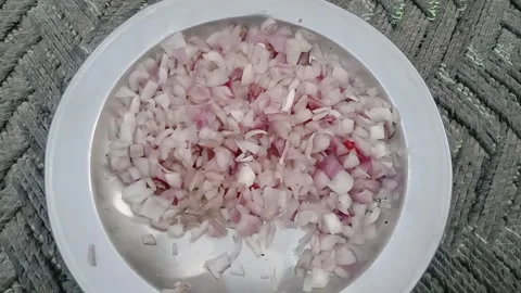 Front View of a Plate Filled with Freshly Cut Onions Stock Footage 346805161