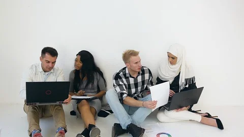 Front view of pleasant clever purposeful mixed race corporate colleagues which Stock Footage 121843425