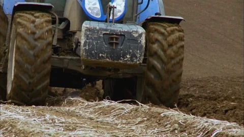 Front View of a Ploughing Tractor, Farm Scene, UK Stock Footage 123882953