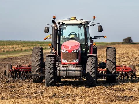 Front view of a plow tractor in a field Stock Photos