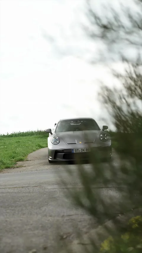 Front view of Porsche 911 GT3 on narrow countryside road in Bayreuth 16.04.2026 Stock-Footage 334082335
