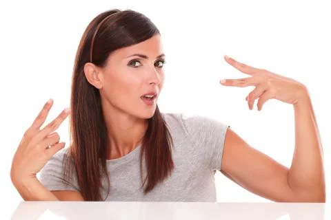 Front view portrait of beautiful hispanic female with winning fingers looking Stock Photos