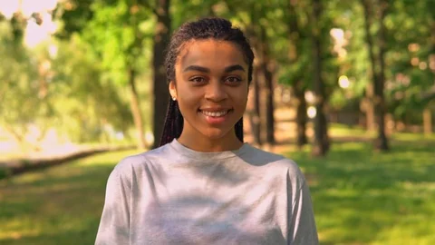 Front view portrait female stroll in park Stock Footage 127847229