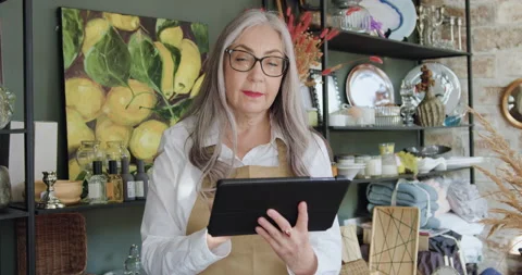 Front view of pretty smiling happy elderly grey-haired woman in glasses which Stock Footage 144001037
