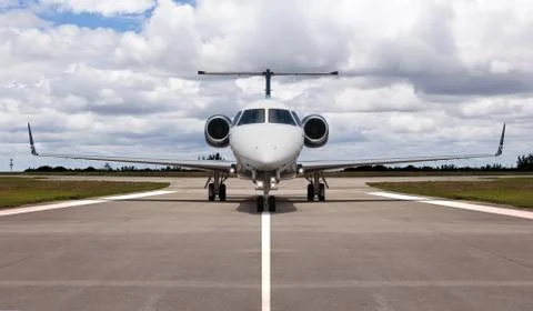Front view of a private jet on the runway Stock Photos