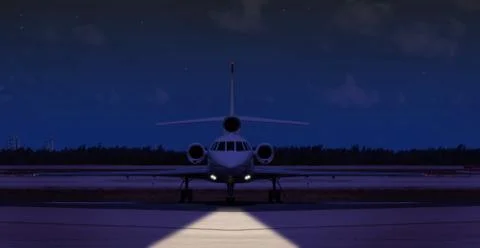 Front view of a private jet on the runway at night Foto stock