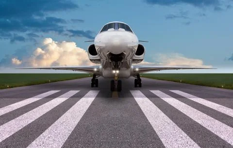 Front view of a private jet on the runway Stock Photos