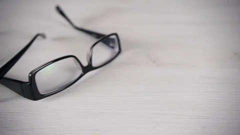 Front view of reading glasses on white table. 스톡 동영상 94818272
