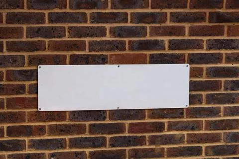 Front view red brick wall facade blank rectangle to write in background. Grunge 스톡 사진