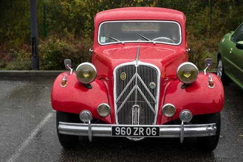 Front view of red Citroen traction parked in the street by rainy day Stock Photos
