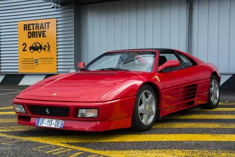 Front view of red ferrari 348 parked in the street Stock Photos