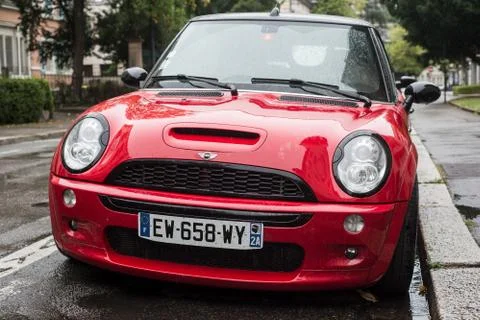 Front view of red mini cooper S  parked in the street by rainy day Stock Photos