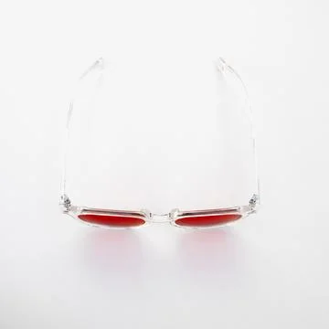 Front view of red tinted glasses with transparent frame, designed for nightti Stock Photos