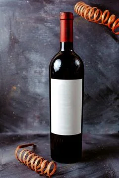 Front view red wine bottle black on the bright floor 写真素材